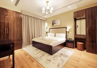 a bedroom with a large bed and a mirror at Stylish 2BR Downtown Apartment Burj & Mall Nearby in Dubai