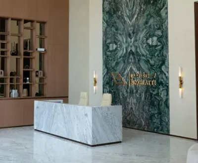 a lobby with two chairs and a sign on a wall at Peaceful 1br Jvc Pool, Balcony, Parking in Dubai
