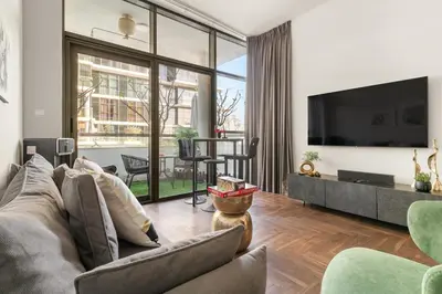 a living room with a couch and a tv at FIRST CLASS Studio Urban Hideaway in Dubai