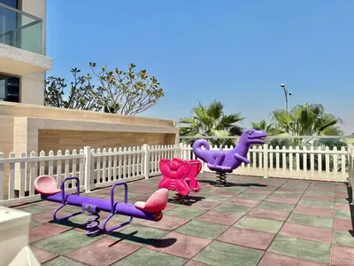 three purple and pink chairs on a patio at FIRST CLASS Studio Urban Hideaway in Dubai