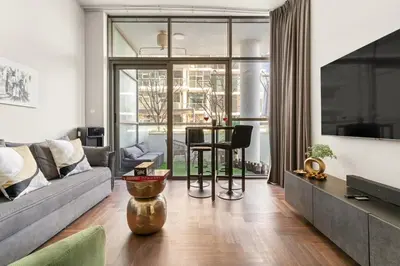 a living room with a couch and a table at FIRST CLASS Studio Urban Hideaway in Dubai