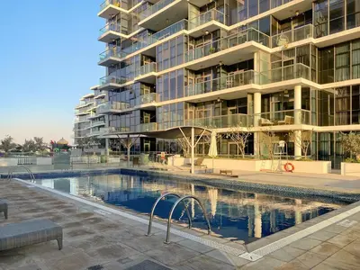 a large apartment building with a large swimming pool at FIRST CLASS Studio Urban Hideaway in Dubai