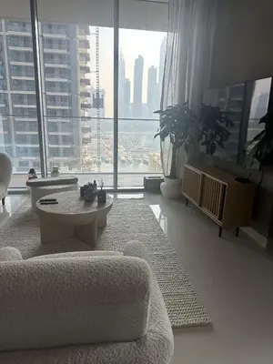 a living room with a couch and a large window at Palm & Marina View 1BR Apartment at Emaar Beachfront in Dubai