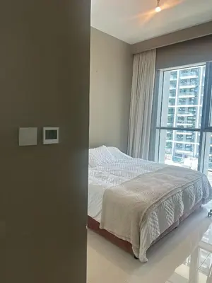 a bedroom with a bed and a large window at Palm & Marina View 1BR Apartment at Emaar Beachfront in Dubai
