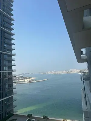 a view of the ocean from a building at Palm & Marina View 1BR Apartment at Emaar Beachfront in Dubai