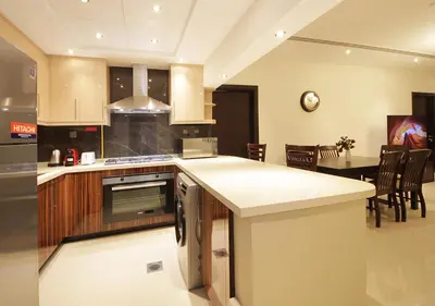 a kitchen with a counter and a dining room at Elegant 2BR with City Views Downtown Dubai Living in Dubai