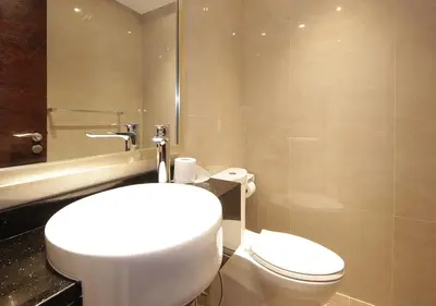 a bathroom with a white toilet and a sink at Elegant 2BR with City Views Downtown Dubai Living in Dubai