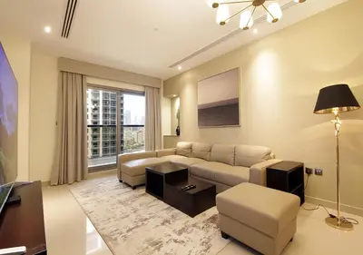 a living room with a couch and a table at Elegant 2BR with City Views Downtown Dubai Living in Dubai