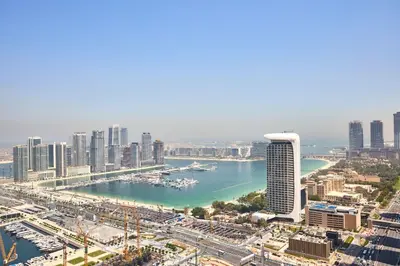an aerial view of a city with a river and buildings at Frank Porter - Cayan Tower in Dubai