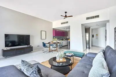 a living room with a couch and a tv at Frank Porter - Cayan Tower in Dubai