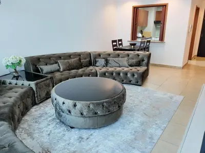 a living room with a couch and a coffee table at Spacious 1 Bedroom Plus Hall in Mag218 in Dubai