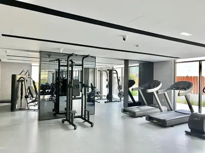 a gym with a bunch of cardio equipment in a room at Prime Studio in the Heart of JVC-Dubai in Dubai