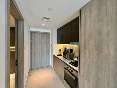 a kitchen with a stove and a microwave at Prime Studio in the Heart of JVC-Dubai in Dubai