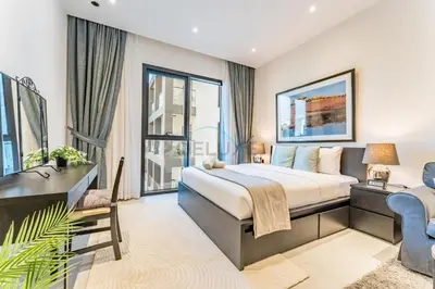 a bedroom with a king sized bed and a window at Near Circle Mall and steps from the park, Hyati Avenue, JVC by Deluxe Holiday Homes in Dubai