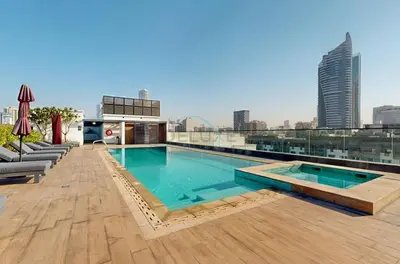 a swimming pool on the roof of a building at Near Circle Mall and steps from the park, Hyati Avenue, JVC by Deluxe Holiday Homes in Dubai