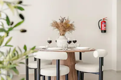 a table with chairs and wine glasses on it at FIRST CLASS 2BR Luxurious Downtown Bliss in Dubai