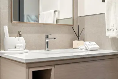 a bathroom with a white sink and a mirror at FIRST CLASS 2BR Luxurious Downtown Bliss in Dubai