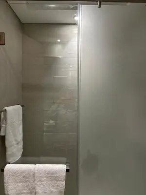 a shower with a glass door in a bathroom at Luxury studio near Burj Khalifa in Dubai