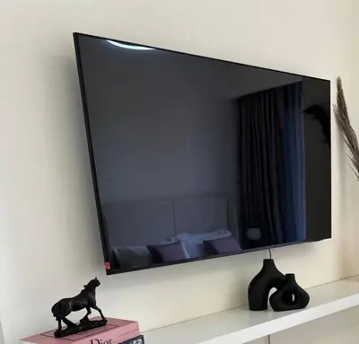 a mirror on a wall with a cat statue on a shelf at Luxury studio near Burj Khalifa in Dubai