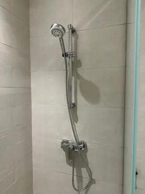 a shower with a shower head in a bathroom at Luxury studio near Burj Khalifa in Dubai