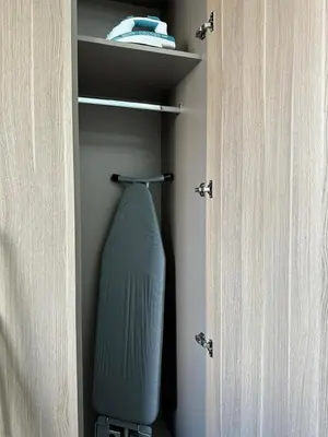 a blue vase is sitting in a closet at Luxury studio near Burj Khalifa in Dubai