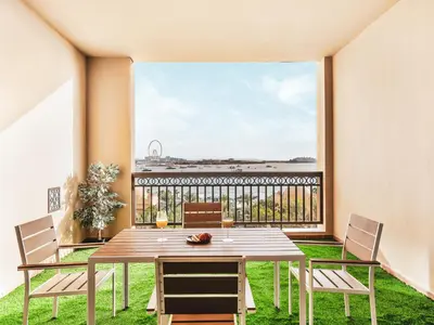 a dining room with a table and chairs and a large window at New Fairmont Residence with private beach on PalmJumeirah in Dubai