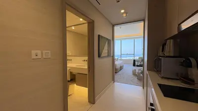a bathroom with a door leading to a bedroom at Ultra-Luxury Studio Palm Tower St. Regis Views High Floor DRP Holiday Homes in Dubai