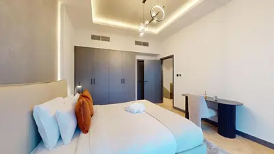 a bedroom with a large white bed and a desk at Azure Residence - Magnificent Three Bed in Marina in Dubai