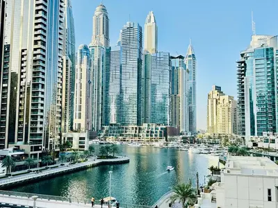 a river in a city with tall buildings at Stylish 1BHK in Marina Steps to Metro & Marina Walk in Dubai