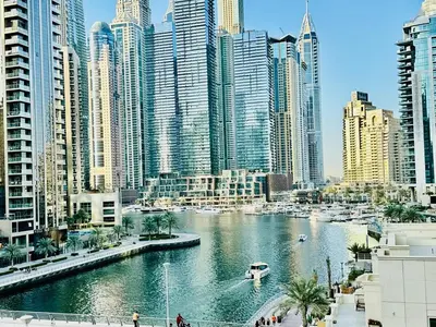a river in a city with many tall buildings at Stylish 1BHK in Marina Steps to Metro & Marina Walk in Dubai