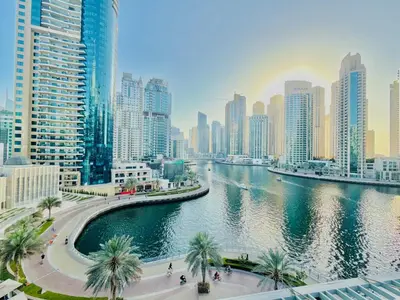 a river in the middle of a city with tall buildings at Stylish 1BHK in Marina Steps to Metro & Marina Walk in Dubai