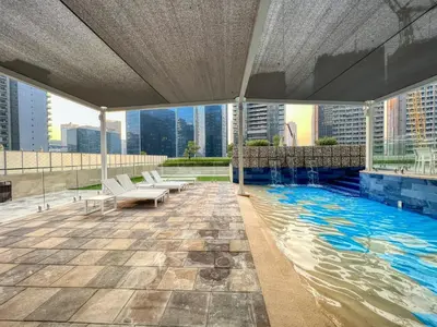 a swimming pool on the roof of a building at 1BR Apartment with Canal View near Dubai Mall & Burj Khalifa in Dubai