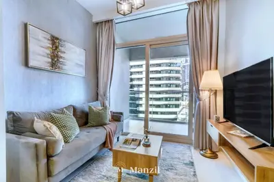a living room with a couch and a large window at 1BR Apartment with Canal View near Dubai Mall & Burj Khalifa in Dubai