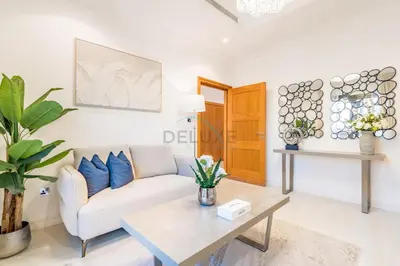a living room with a couch and a table at Near the Beach 4BR Villa with Assistant's Room, Minutes Away from the Mall and Monorail, Canal Cove, Palm Jumeirah by Deluxe Holiday Homes in Dubai