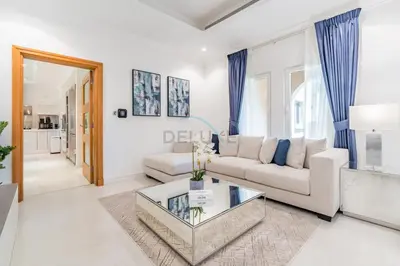 a living room with a couch and a table at Near the Beach 4BR Villa with Assistant's Room, Minutes Away from the Mall and Monorail, Canal Cove, Palm Jumeirah by Deluxe Holiday Homes in Dubai