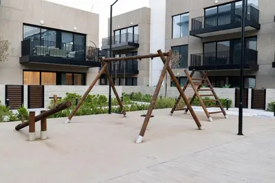 an empty playground in front of a building at Luxurious 2BR in Oakley Square Residence, JVC in Dubai