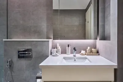 a bathroom with a sink and a mirror at Bright and Modern City Apartment in Business Bay with Two Balconies, Pool, Gym, free Parking and Self Check In, Sleeps up to Four, by Stayfinity in Dubai