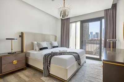 a bedroom with a white bed and a large window at Bright and Modern City Apartment in Business Bay with Two Balconies, Pool, Gym, free Parking and Self Check In, Sleeps up to Four, by Stayfinity in Dubai