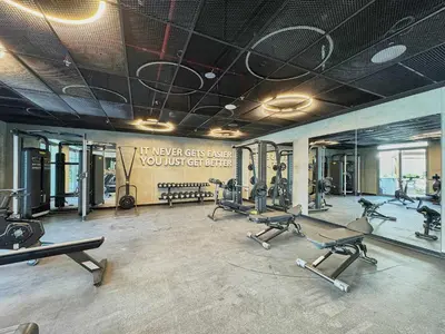 a gym with several treadmills and cardio machines at Frank Porter - Gemz by Danube in Dubai