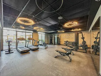 a gym with several treadmills and exercise bikes at Frank Porter - Gemz by Danube in Dubai