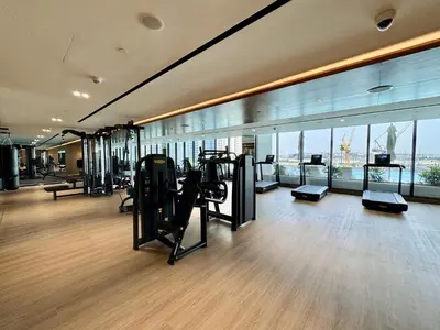 a gym with cardio equipment in a building at Exclusive 1 Bedroom in Trillionaire Residences in Dubai