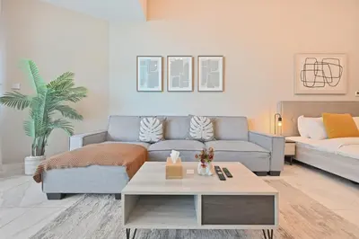 a living room with a couch and a coffee table at Stylish Escape with Balcony, Canal and Burj Khalifa Views Near Dubai Mall in Dubai