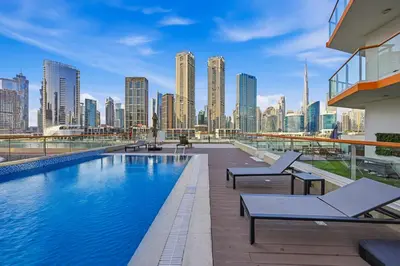 a swimming pool with a view of a city skyline at Stylish Escape with Balcony, Canal and Burj Khalifa Views Near Dubai Mall in Dubai