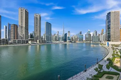 a view of a river in a city with skyscrapers at Stylish Escape with Balcony, Canal and Burj Khalifa Views Near Dubai Mall in Dubai