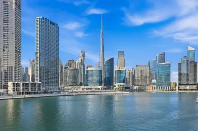 a view of a city with a river and skyscrapers at Stylish Escape with Balcony, Canal and Burj Khalifa Views Near Dubai Mall in Dubai