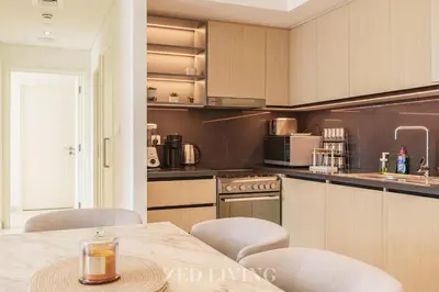 a kitchen with a table and chairs in a room at Burj Crown - Spectacular 2 BR next to Burj Khalifa - Zed Living in Dubai