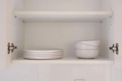 a shelf with two plates and a bowl on it at Stunning City Views and Outdoor Pool, Steps from Iconic Burj Khalifa in Dubai