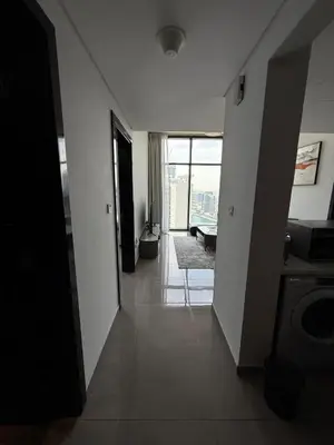 a hallway with a view of a living room with a window at Damac MERANO LUX 2 bedroom 3 baths in Dubai