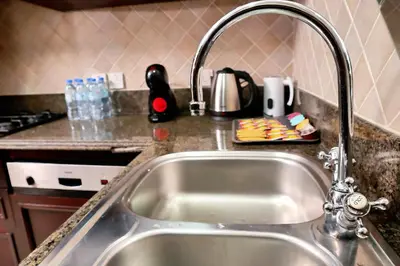 a kitchen sink with a faucet in a kitchen at Full View Burj Khalifa and Fountains -Souk Al Bahar- Dream View holiday Home Rental in Dubai