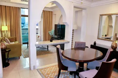 a living room with a dining table and a living room at Full View Burj Khalifa and Fountains -Souk Al Bahar- Dream View holiday Home Rental in Dubai